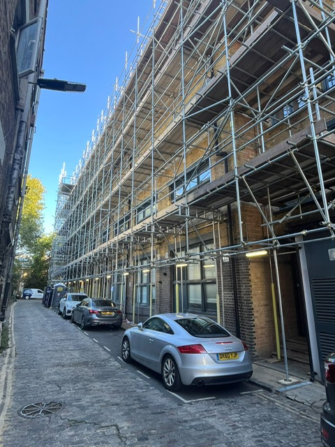 Street-level commercial scaffolding on a brick building — Elm Site Services