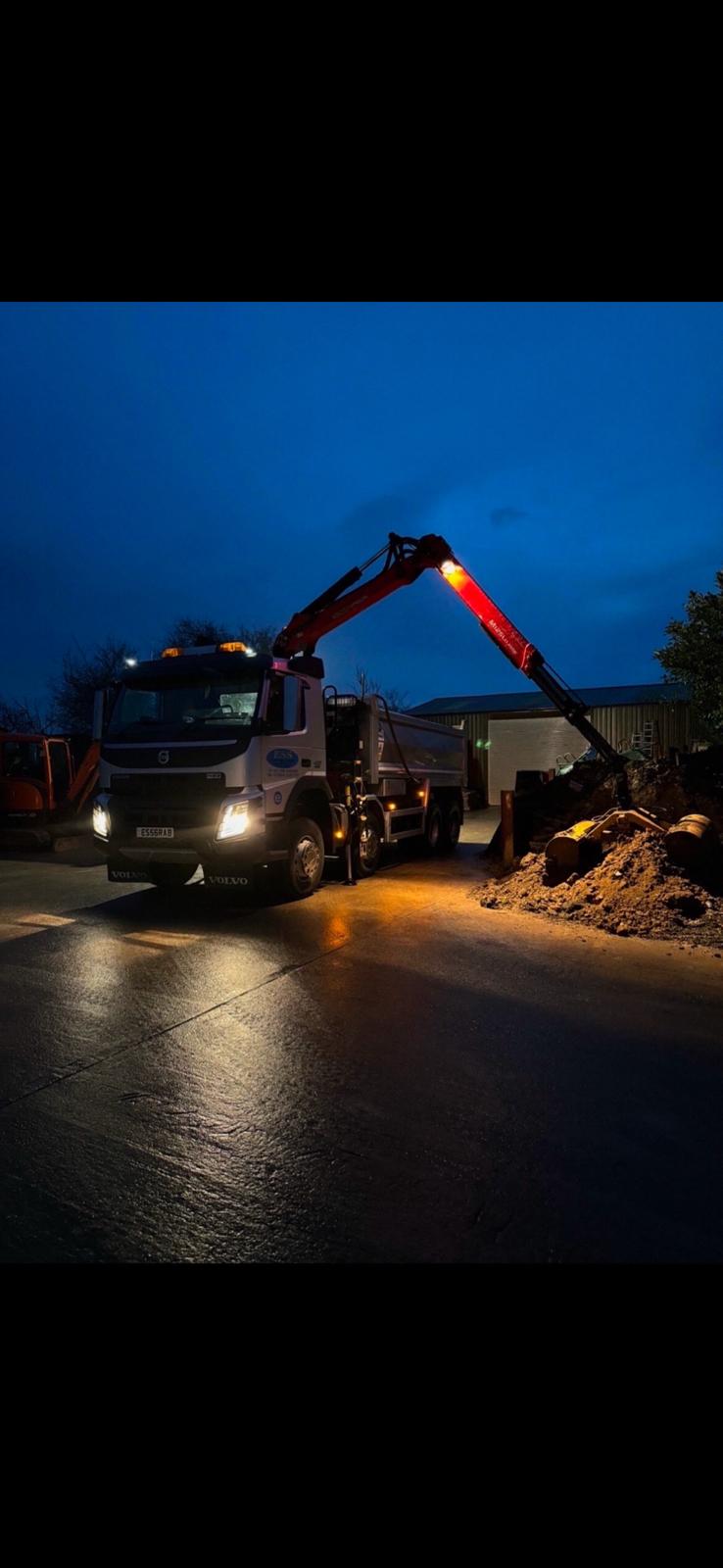 Elm Site Services grab lorry working at night with the crane extended