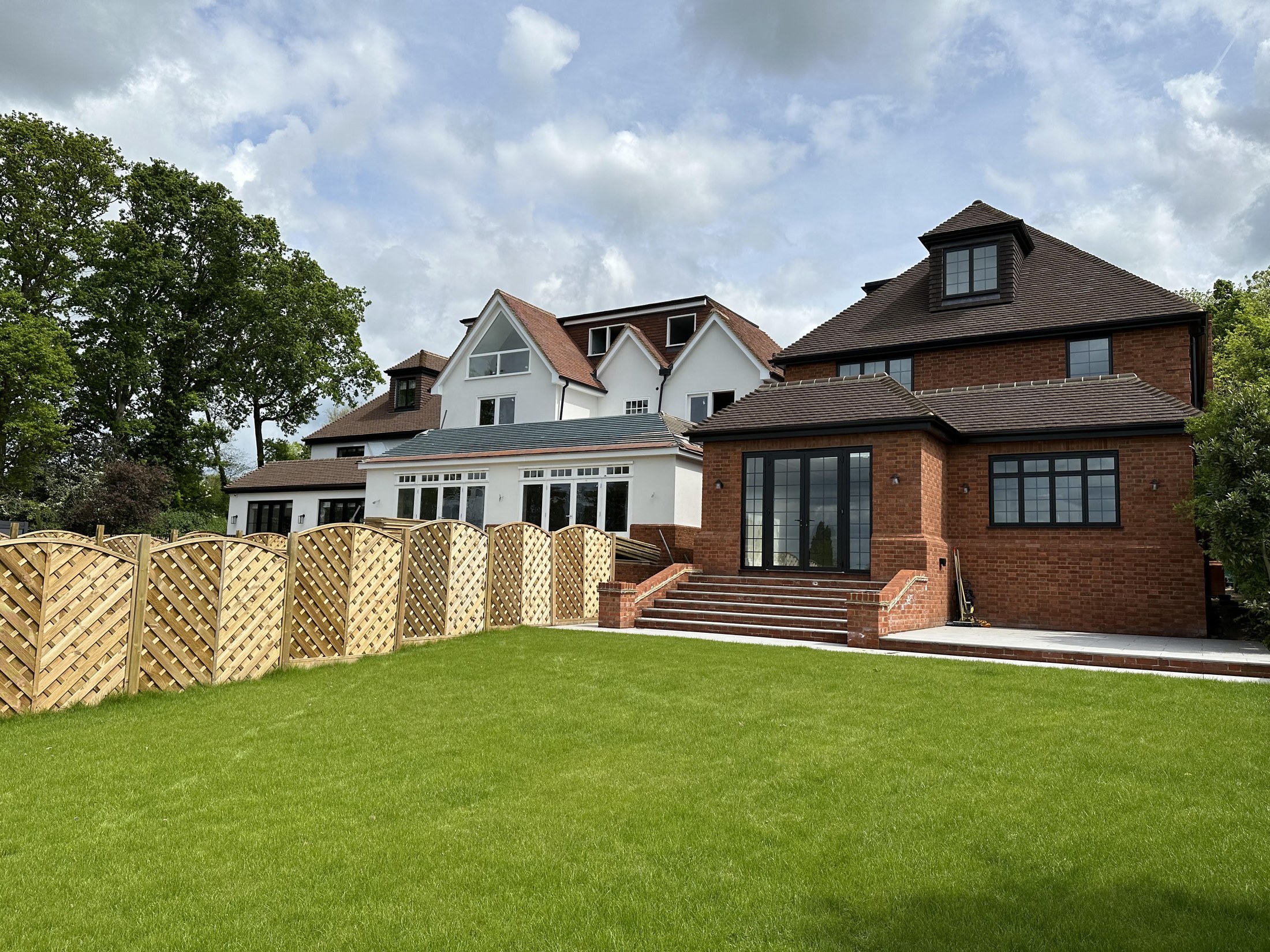 Modern new-build house with a large black-framed glazed gable — Elm Site Services