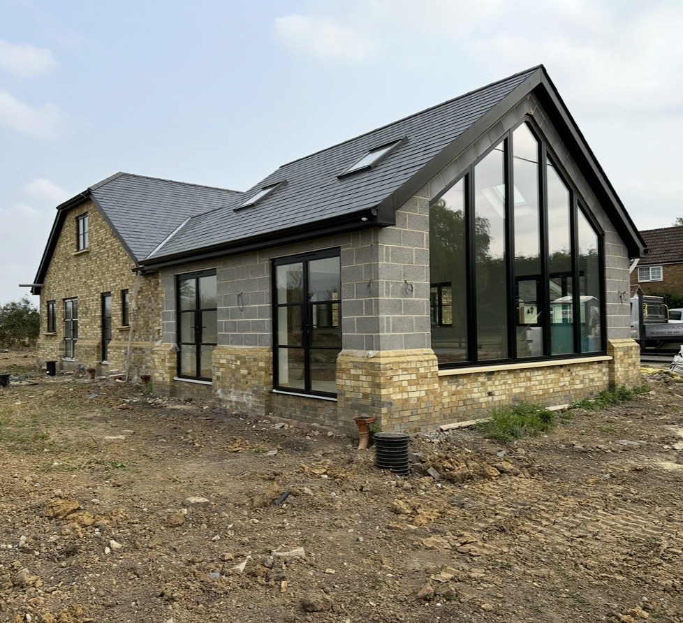 New-build house under construction with a glazed gable — Elm Site Services