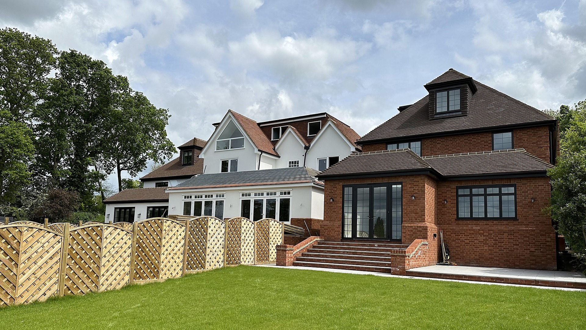 Modern new-build house with a large black-framed glazed gable — Elm Site Services