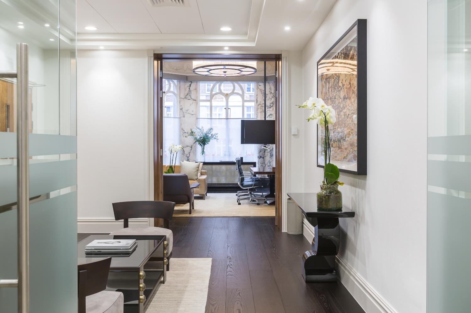 Glazed corridor looking into a fitted office — Elm Site Services