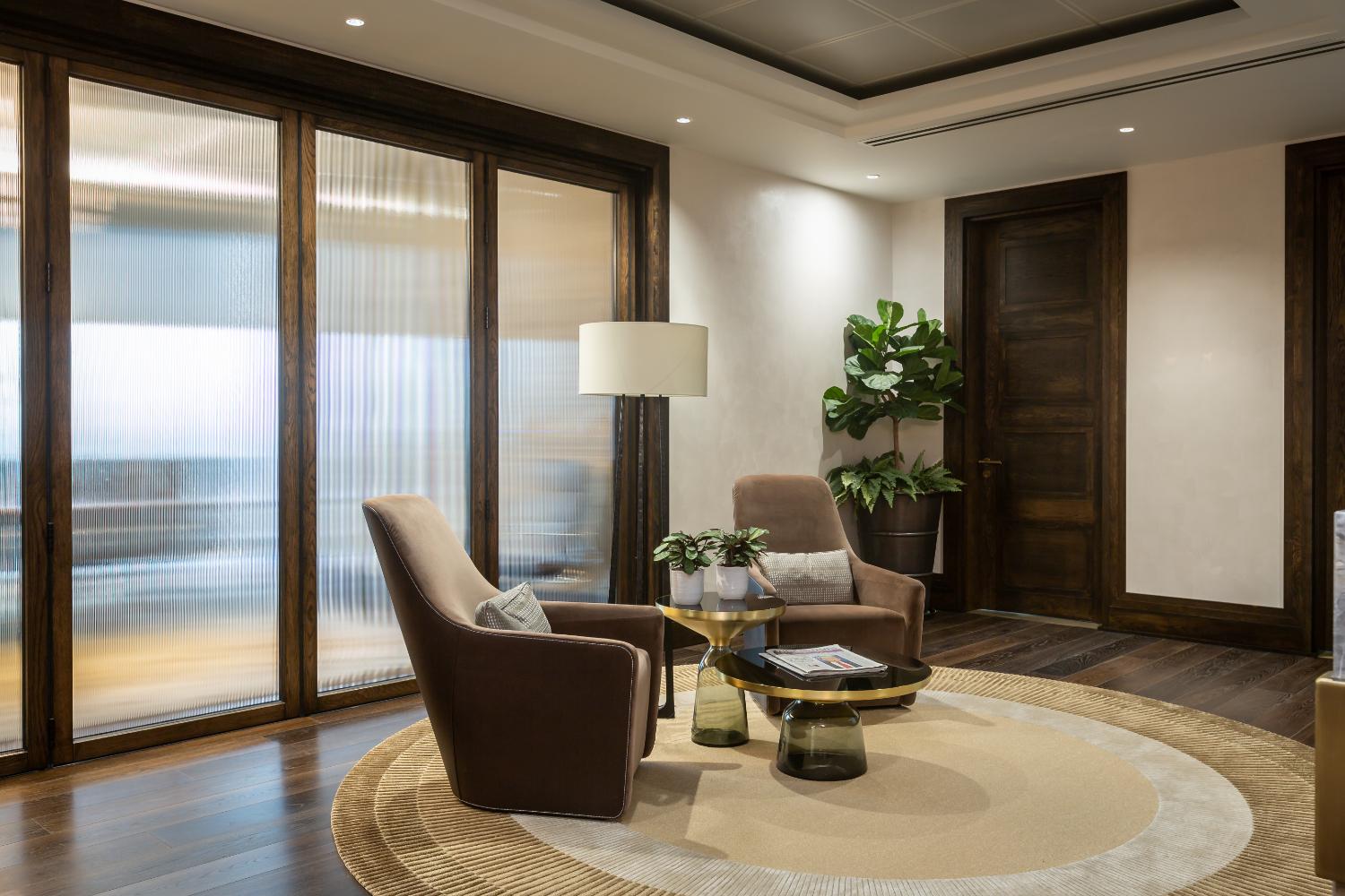 Seating area beside fluted glass screens — Elm Site Services