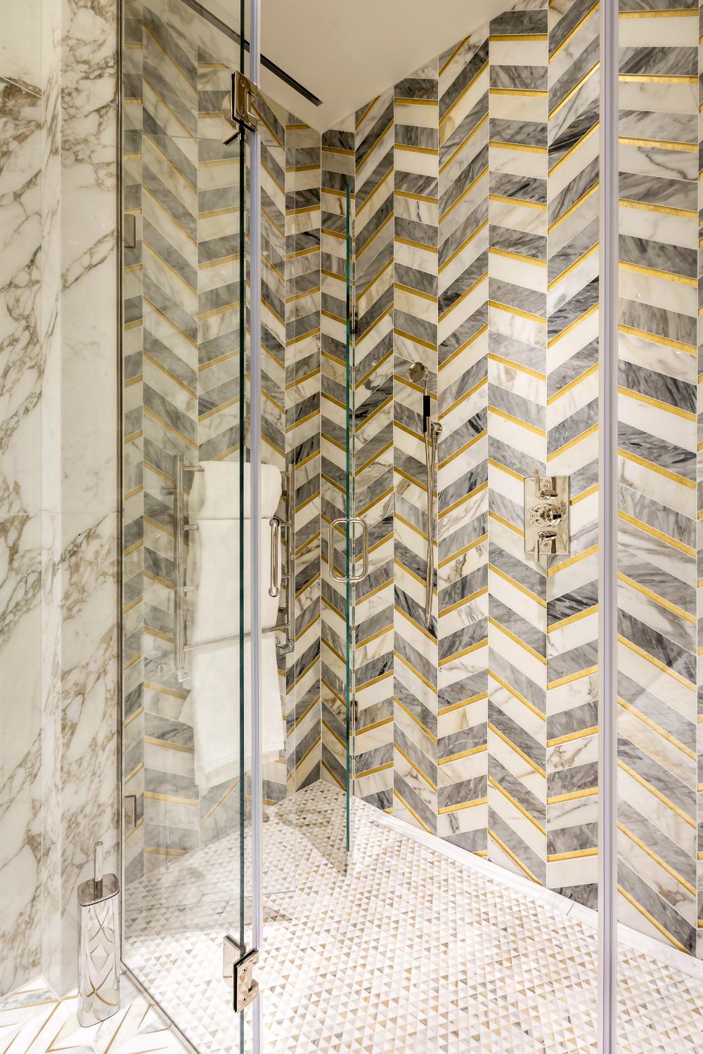 Marble shower with chevron tiling — Elm Site Services