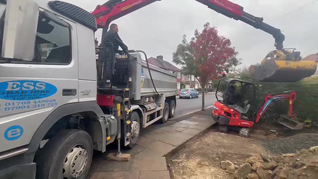 Elm Site Services grab lorry loading material on a residential street